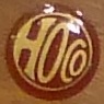 Ursprüngliches HOCO-Emblem von 1924 in Braun und Gold mit Schriftzug